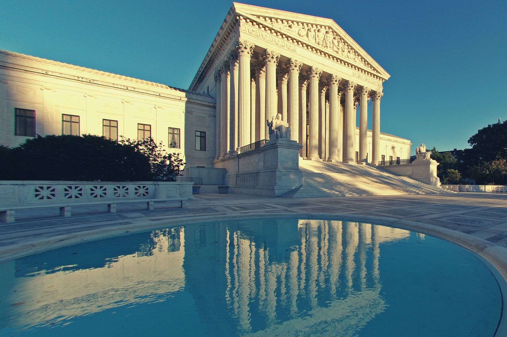 Image of supreme court being reflected in a pool of wahter