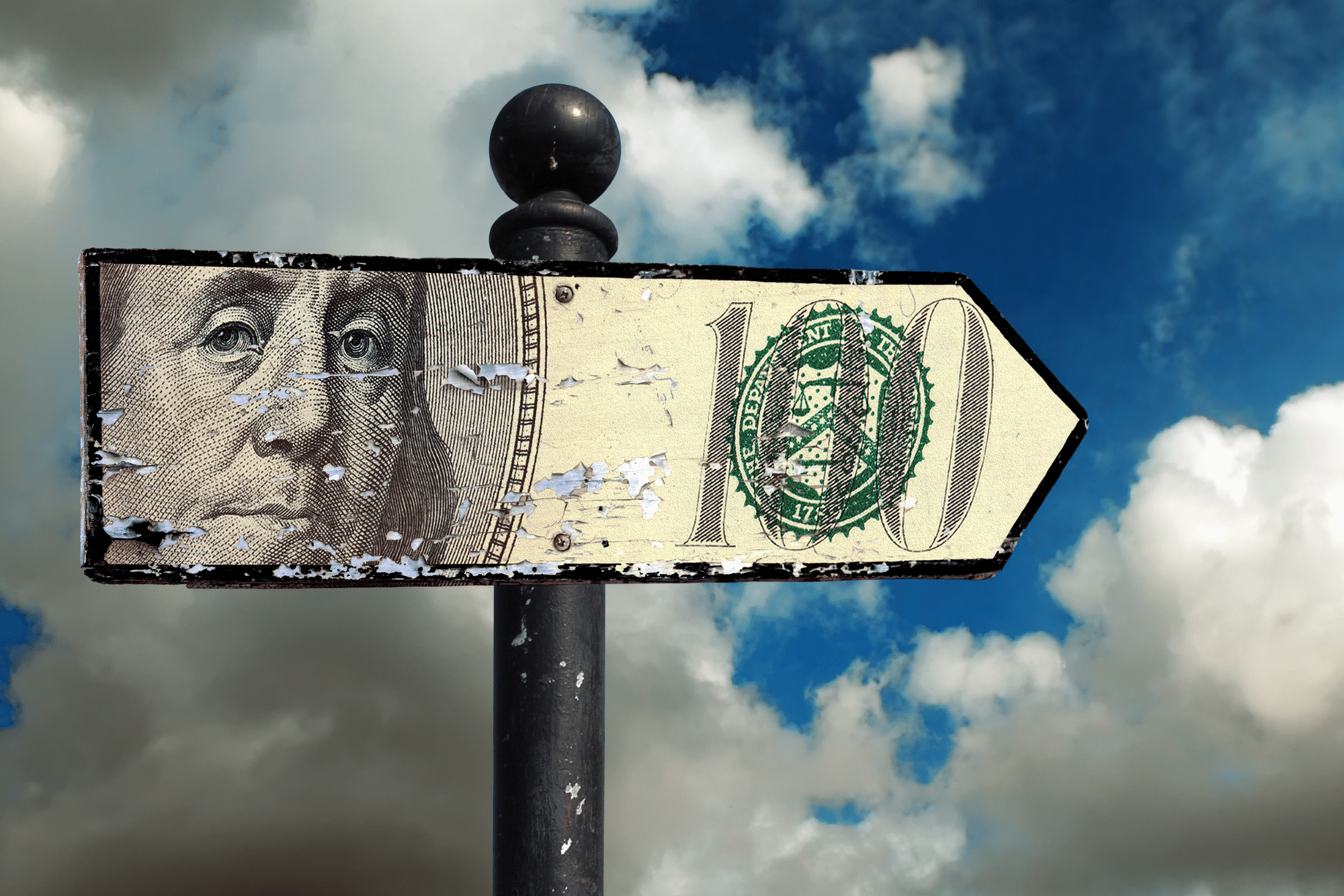 Money on a sign with dark clouds in the background